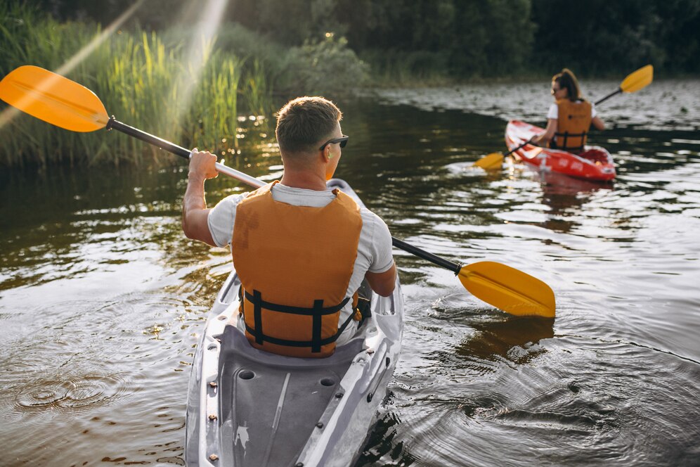 couple-together-kayaking-river_1303-16041